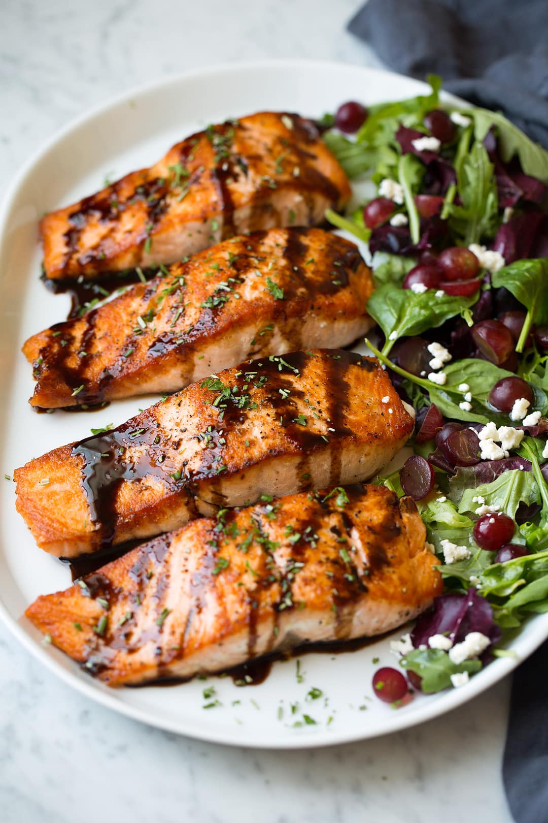 Balsamic Salmon fillets on platter with salad