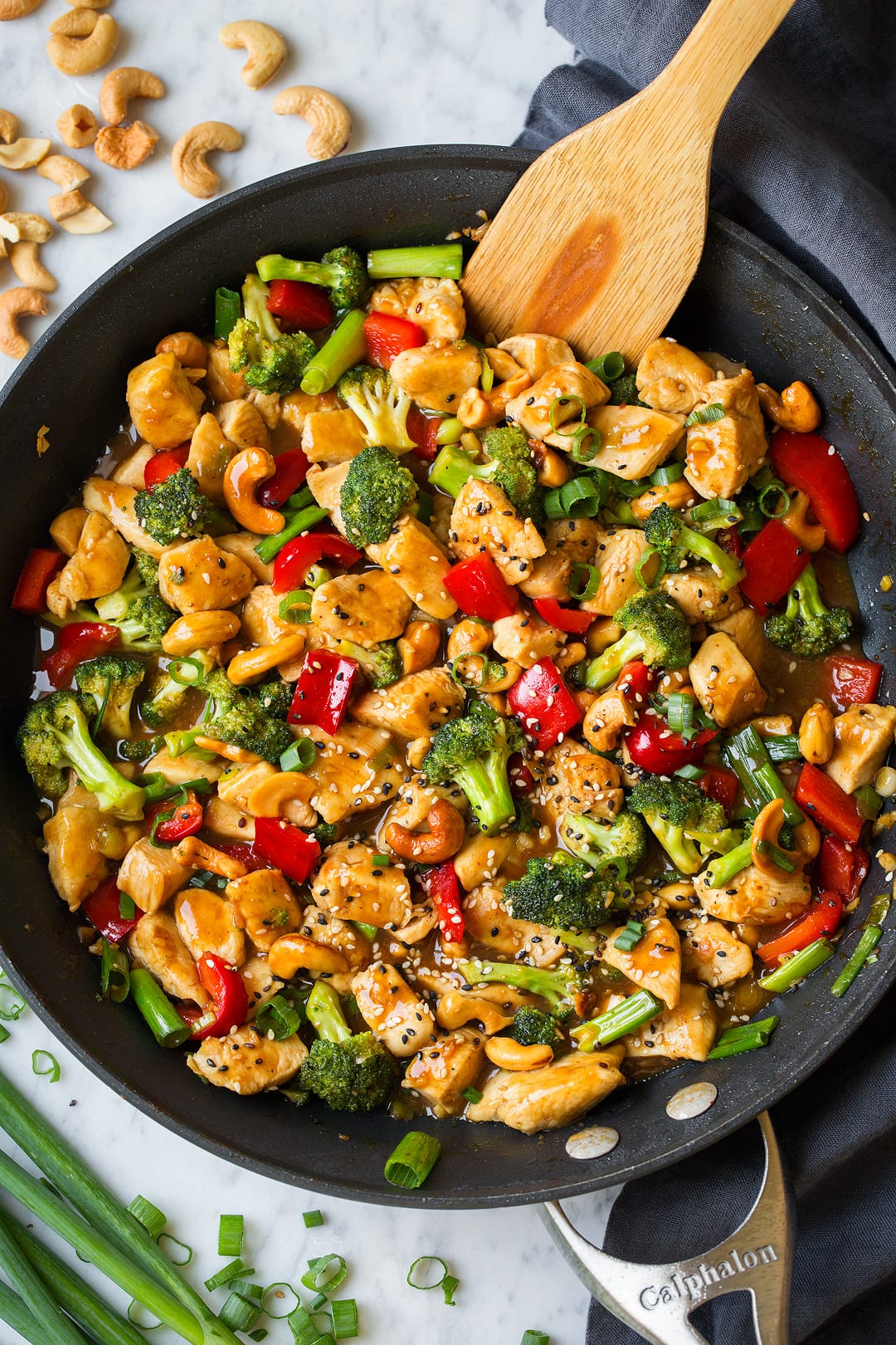 Cashew Chicken shown here in skillet. Includes chicken breasts pieces, broccoli, bell peppers and a sweet and tangy sauce.