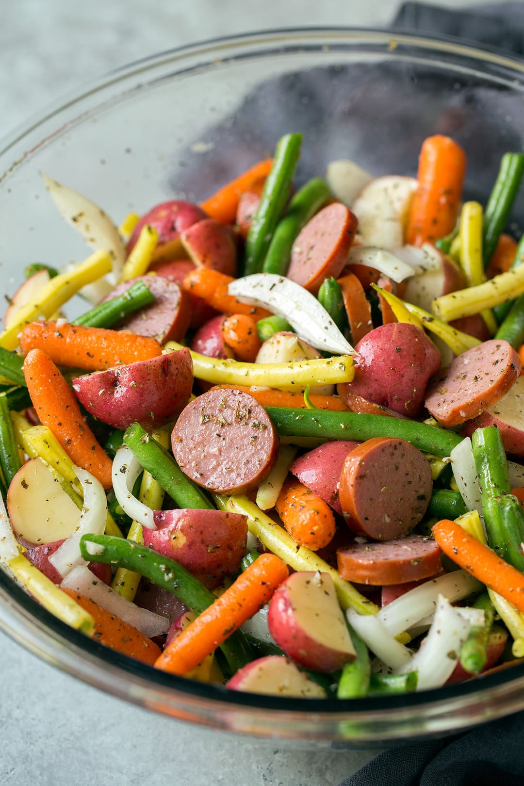 Easy Sausage and Veggie Foil Packs in mixing bowl.