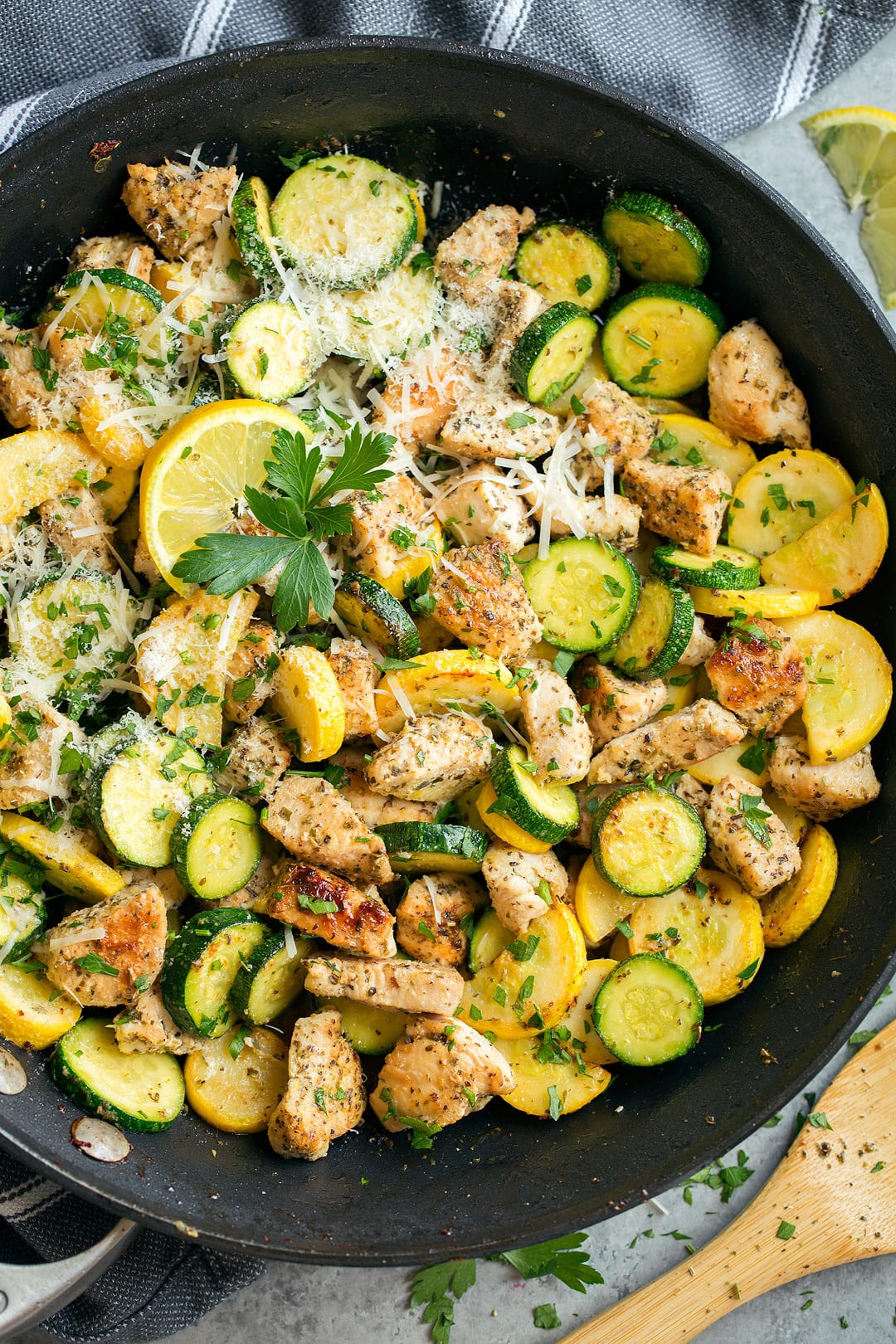 Skillet Lemon Parmesan Chicken with Zucchini and Squash garnished with Parmesan and parsley