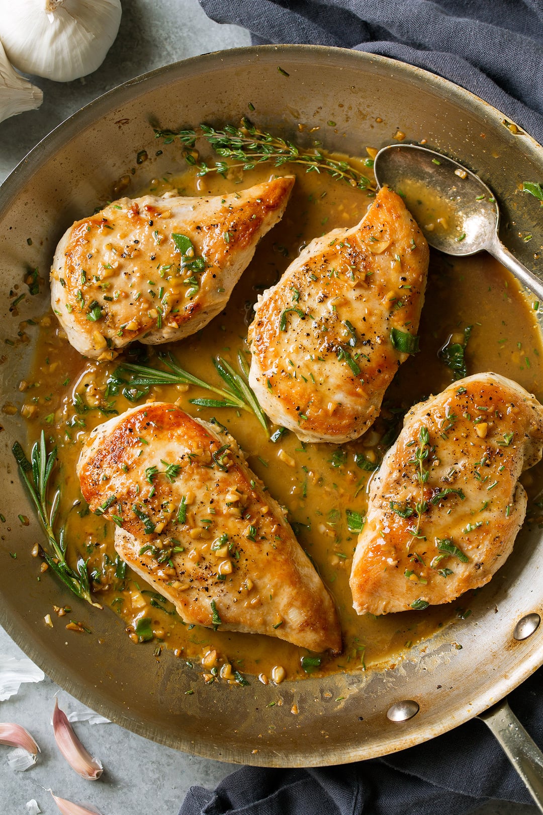 Skillet Chicken with Garlic Herb Butter Sauce in a skillet pan with a spoon