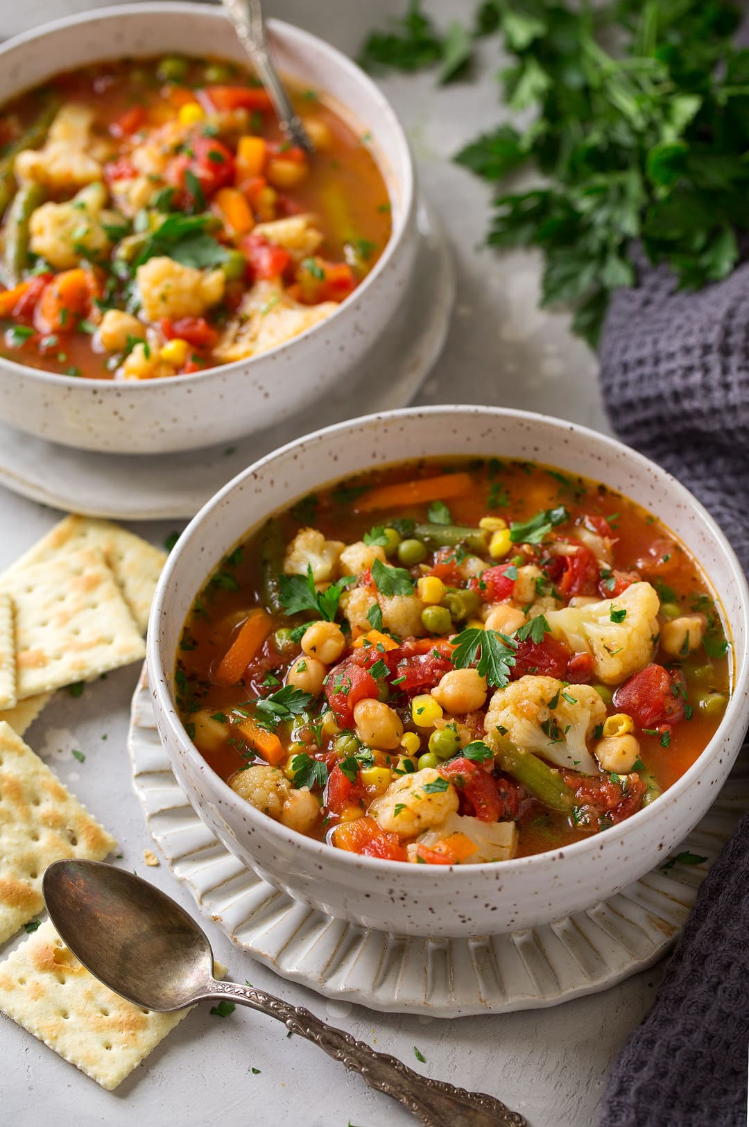 Two servings of Vegetable Soup shown here, with additions of cauliflower, frozen vegetables, canned tomatoes, and chick peas.