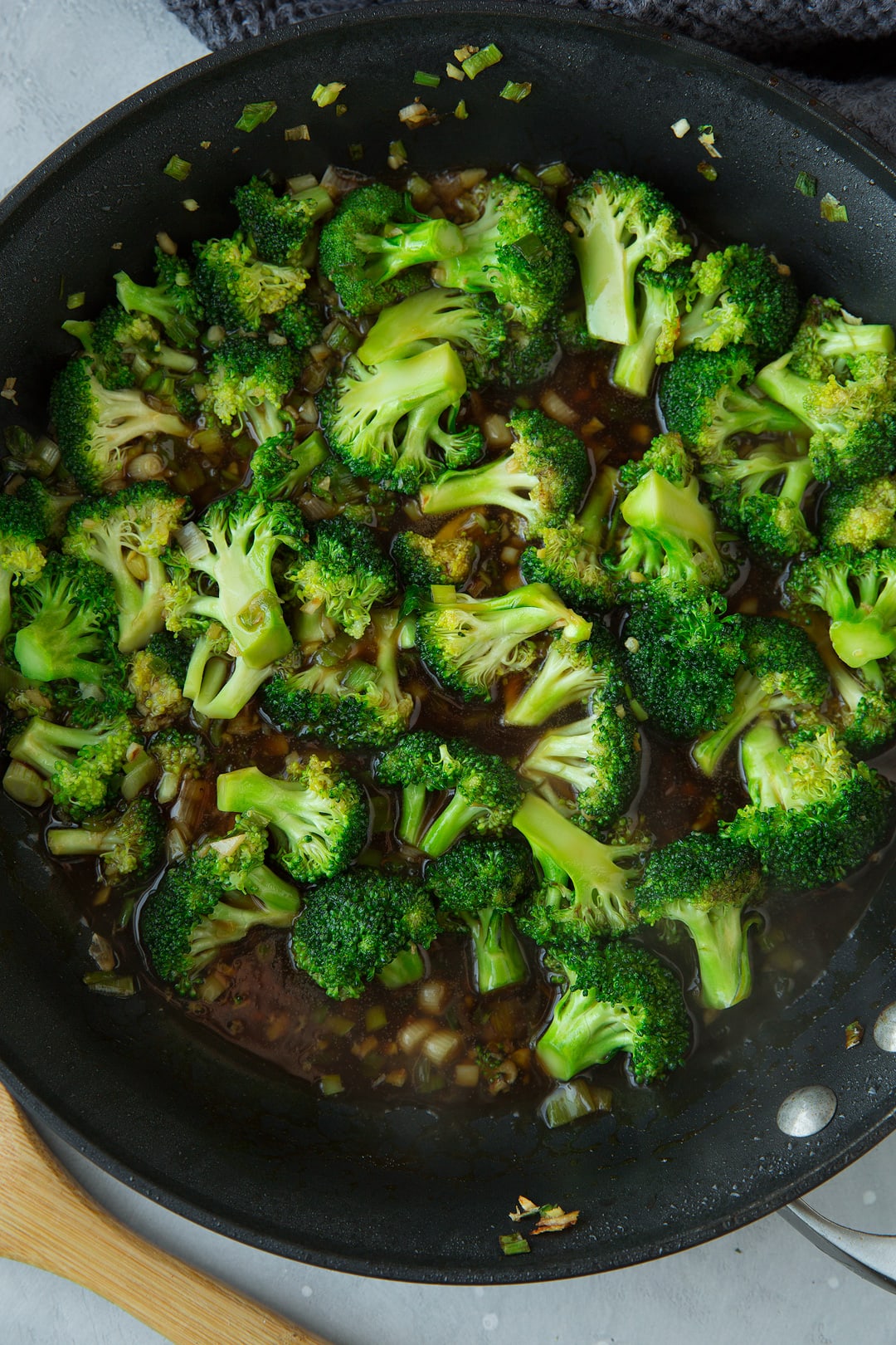 Sauteed broccoli and garlic in skillet for chicken and broccoli stir fry