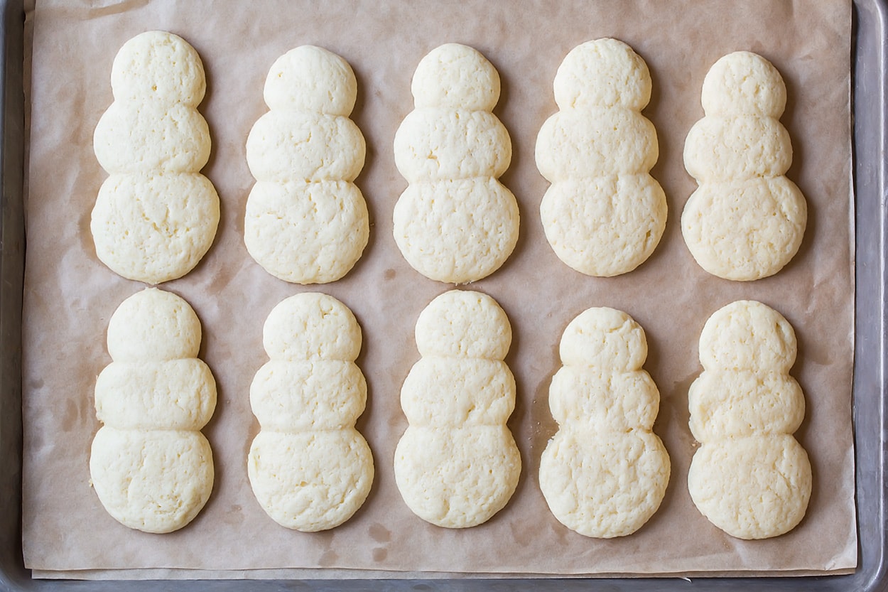 Soft sugar cookies after baking in snowman shape.