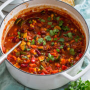 Vegetarian chili in a large white pot.