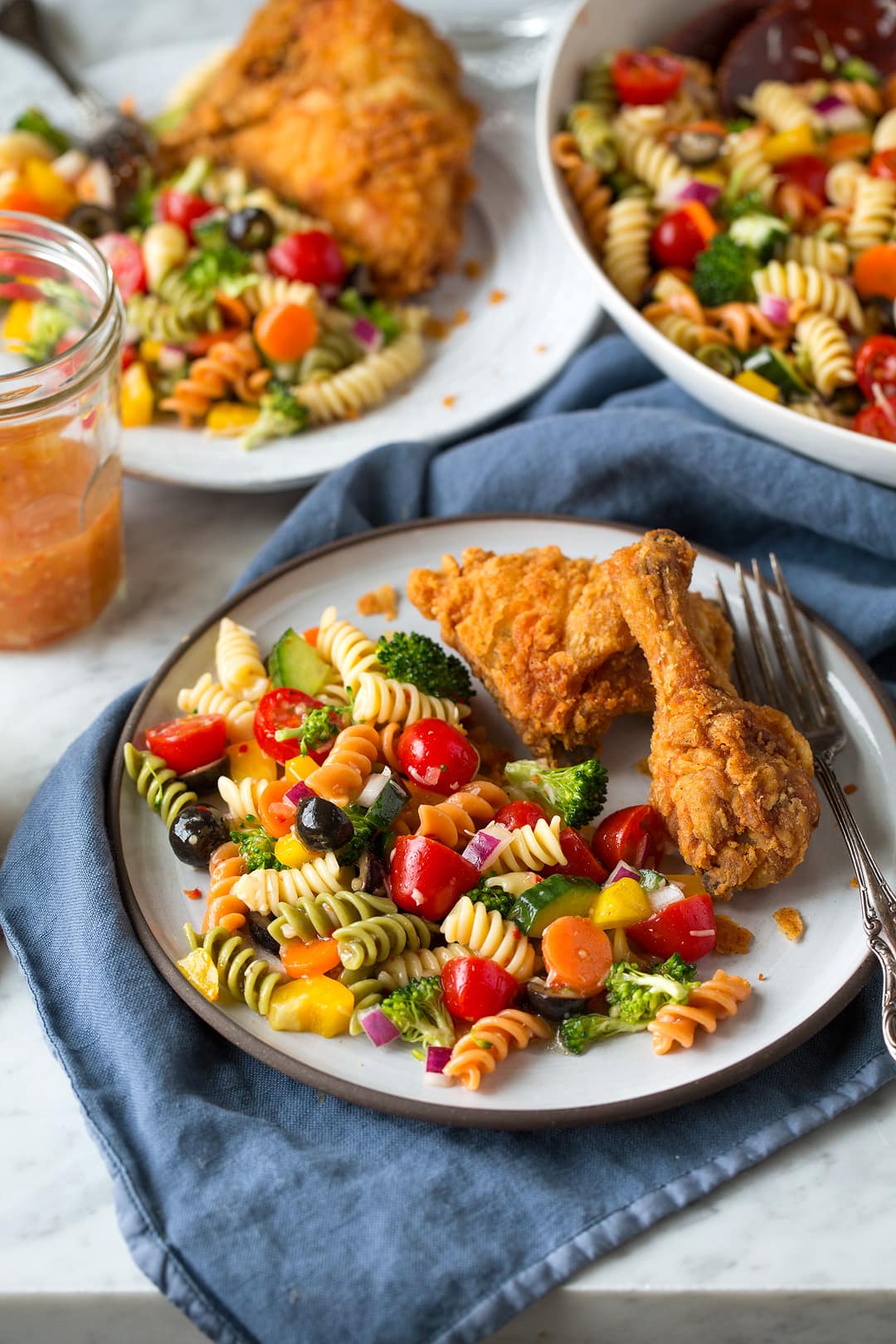 Garden Pasta Salad on a plate with fried chicken