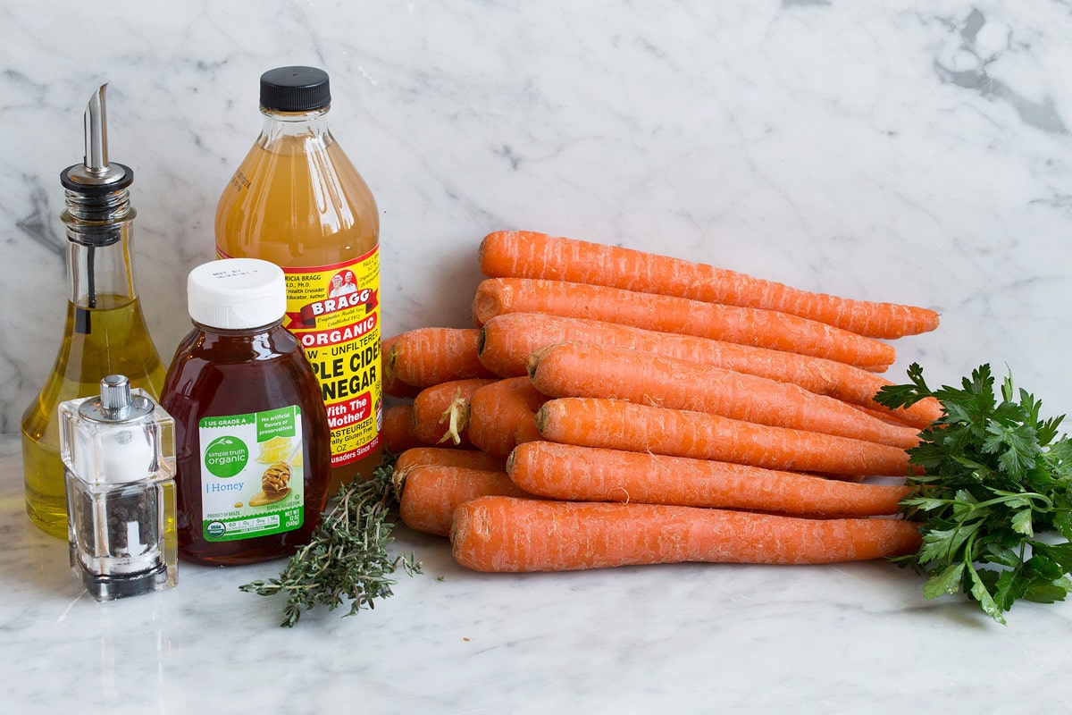 Photo: Shows carrots, parsley, apple cider vinegar, honey, thyme, olive oil, salt and pepper. These are ingredients used to make roasted carrots.
