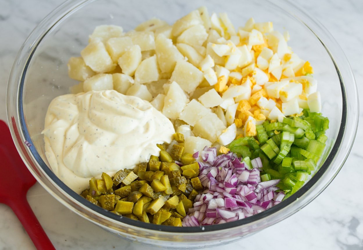 potato salad ingredients in a bowl ready to mix together