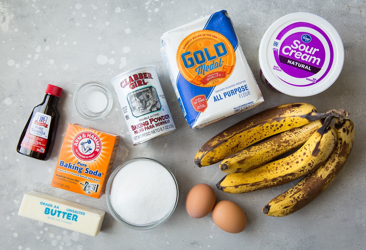 homemade banana bread ingredients on a gray surface