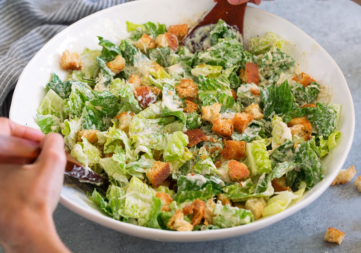 Tossing Caesar Salad in Salad Bowl
