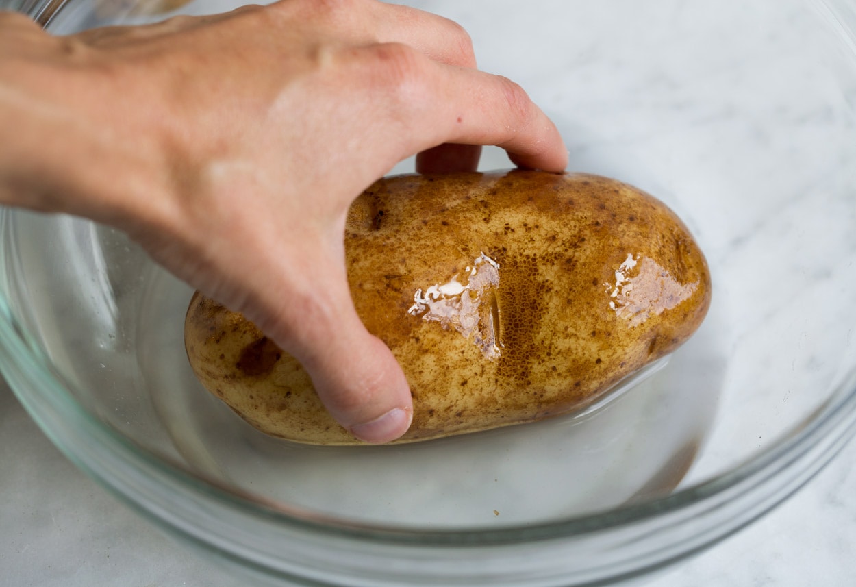 Baked Potatoes shown here rolling in salt water brine before baking