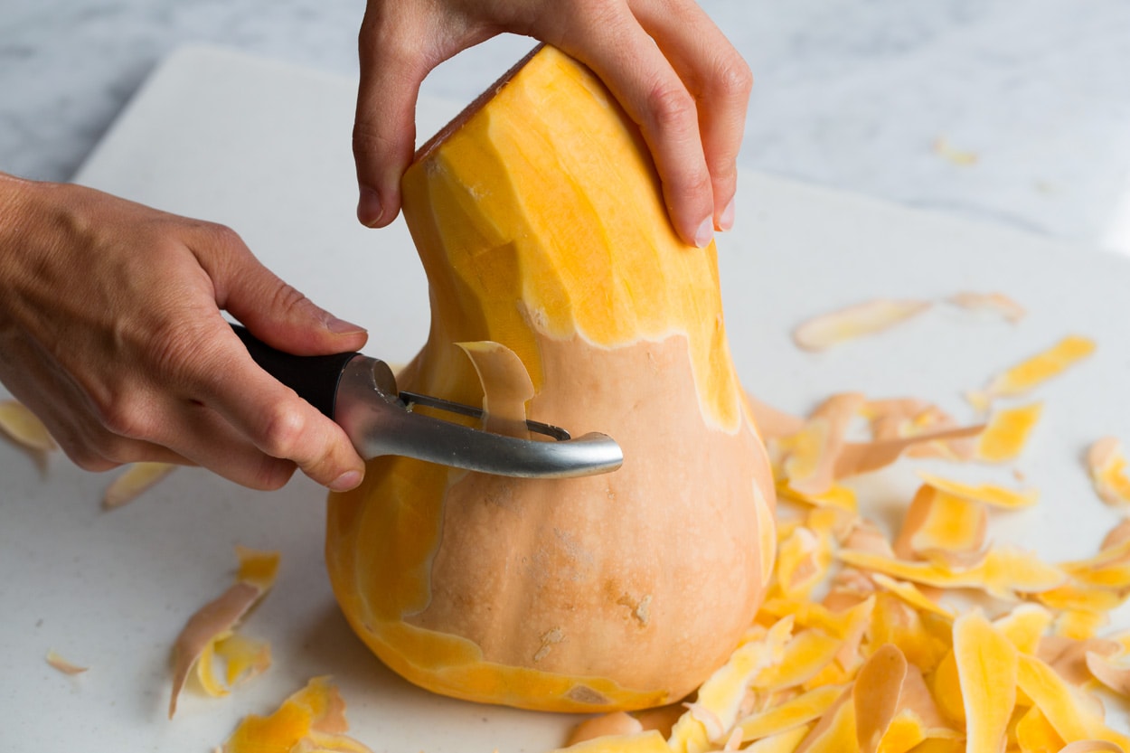 Showing how to peel a butternut squash.
