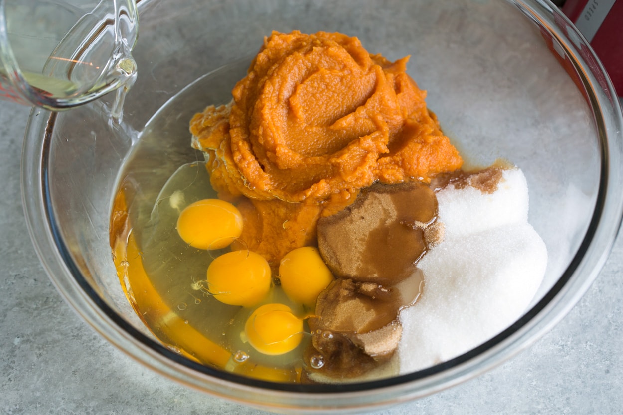 Pumpkin cake shown here mixing eggs sugars pumpkin and oil in mixing bowl