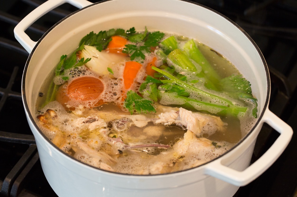 Image showing how to make homemade chicken stock in a pot on the stovetop.