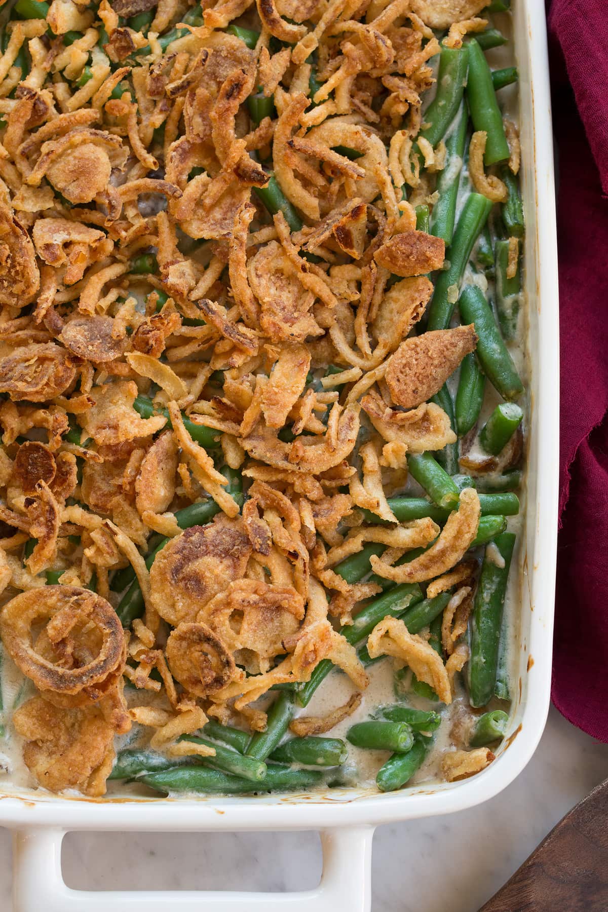 Close up overhead image of green bean casserole showing texture of topping and filling.