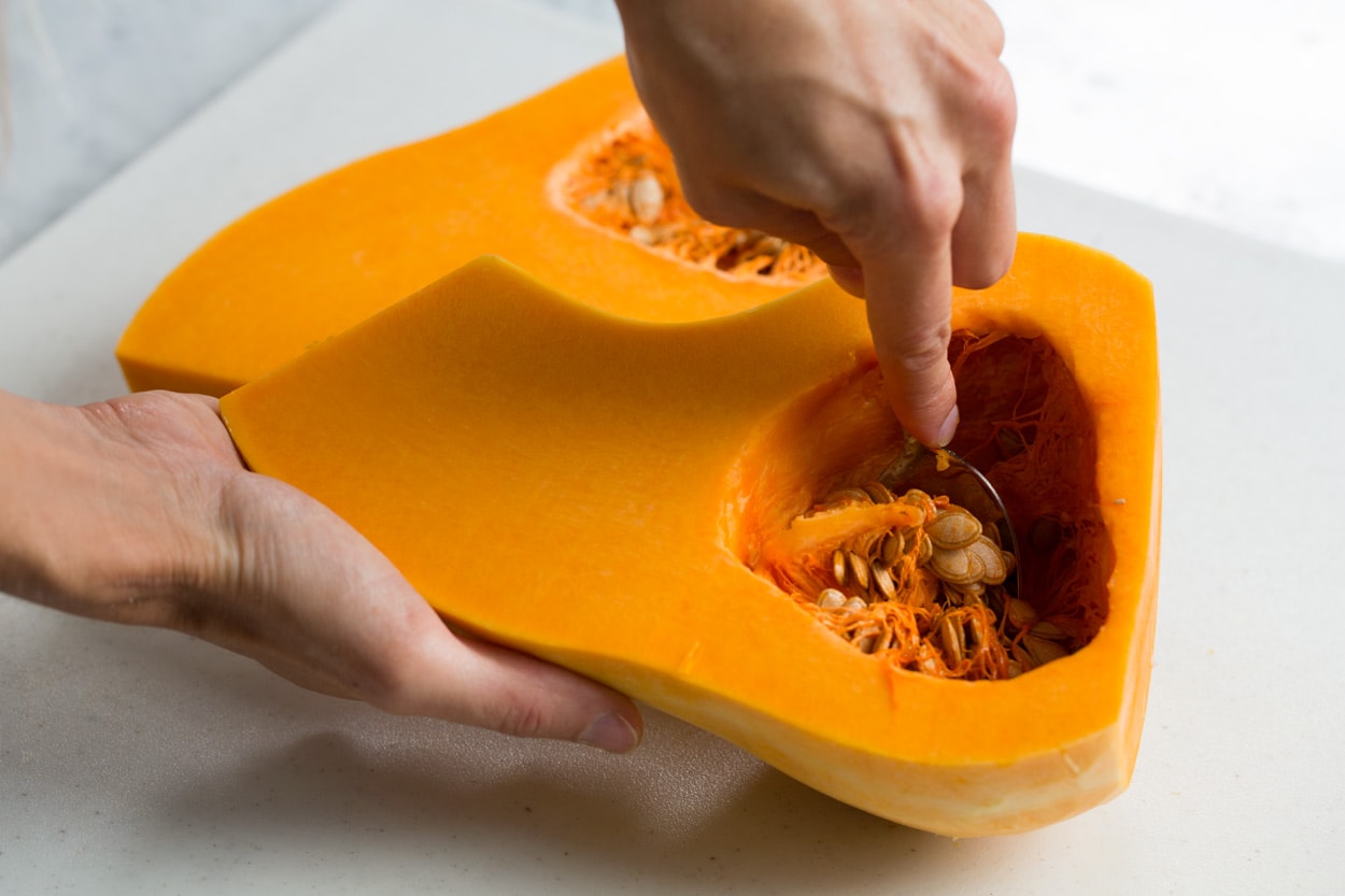 Showing how to seed a butternut squash.