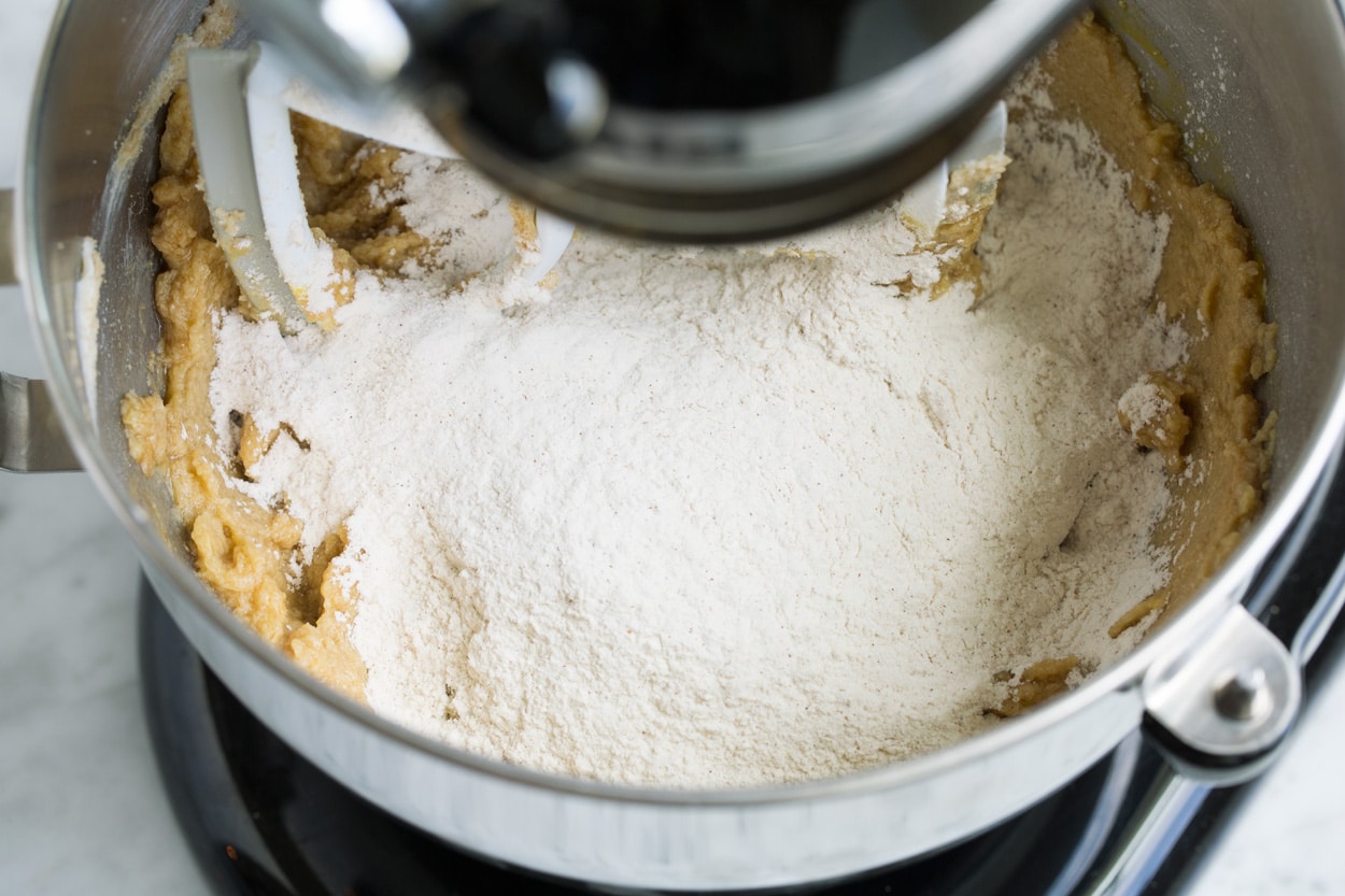 Adding flour mixture to stand mixer.