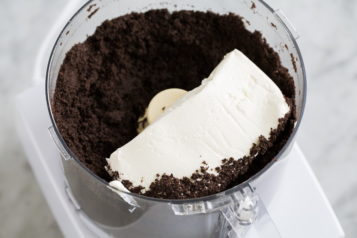 Cream cheese added to crushed oreos in a food processor.