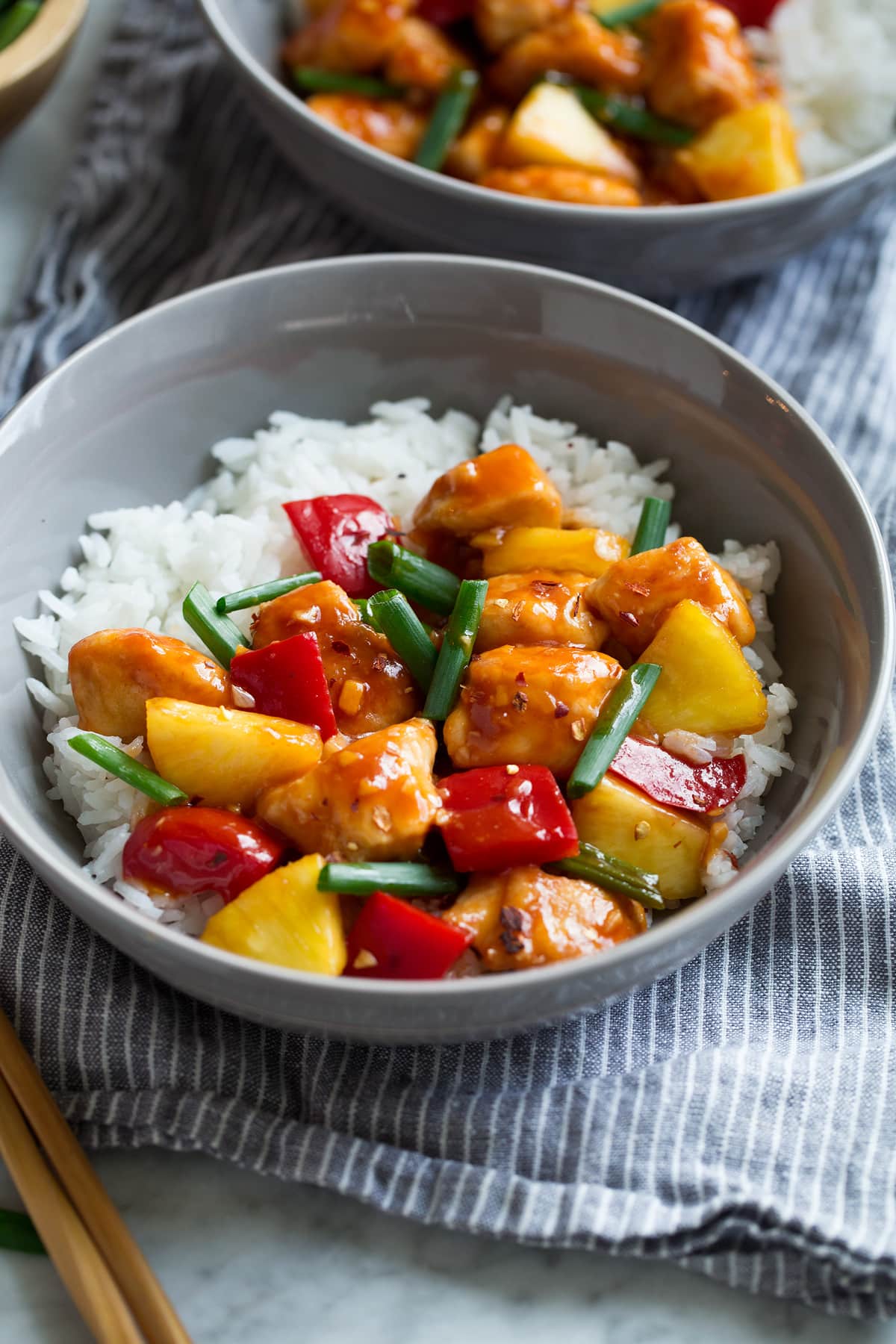 Sweet and Sour Chicken in serving bowl with white rice.