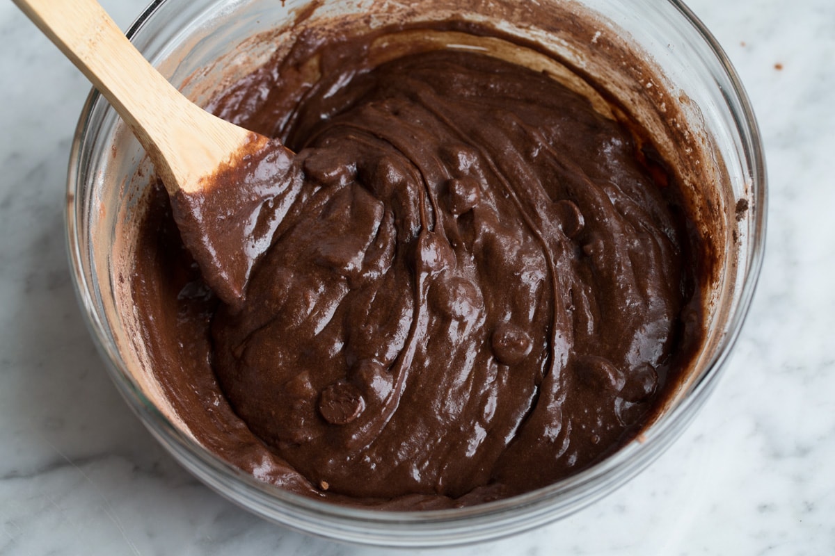 Finished brownie batter in glass mixing bowl.