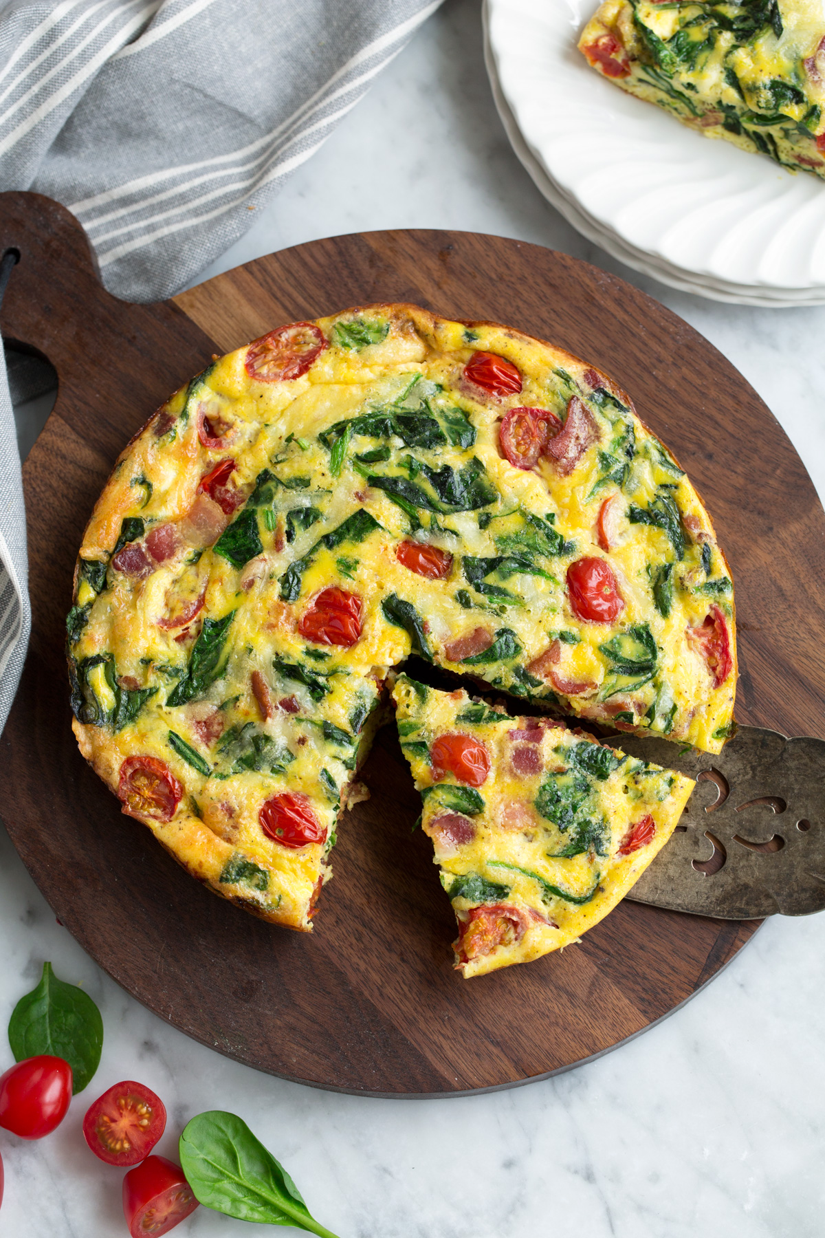 Sliced frittata on a wooden surface.