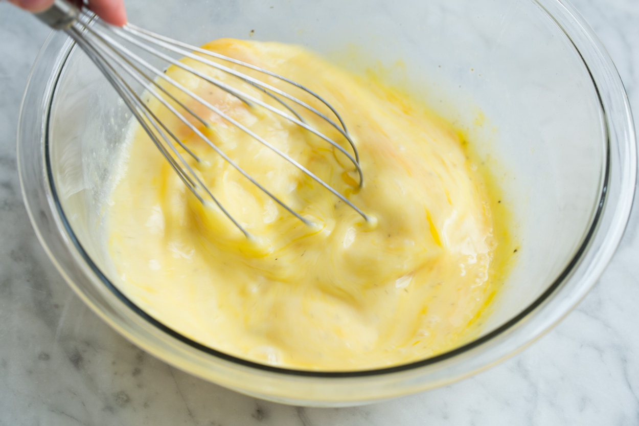 Whisking egg mixture in glass mixing bowl.