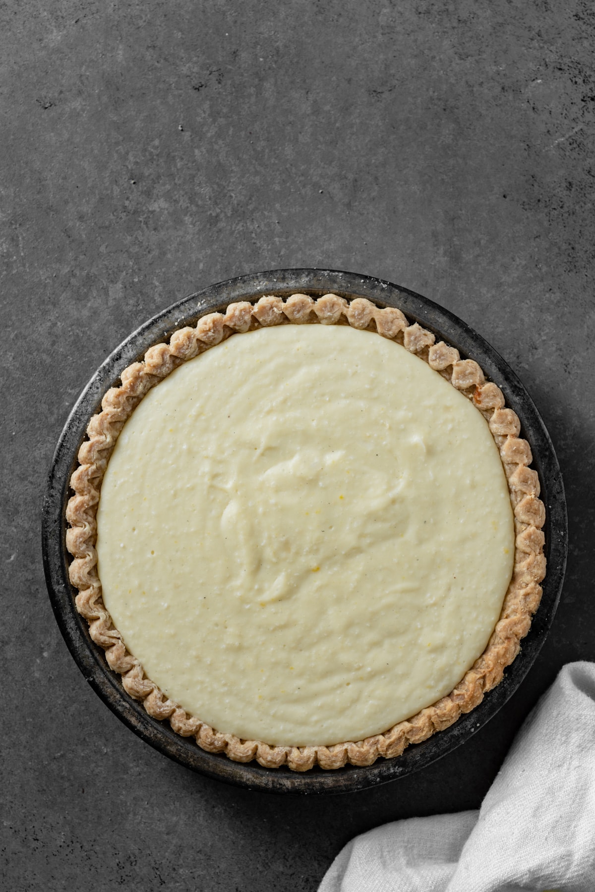Showing coconut cream pie filling in a baked pie crust.