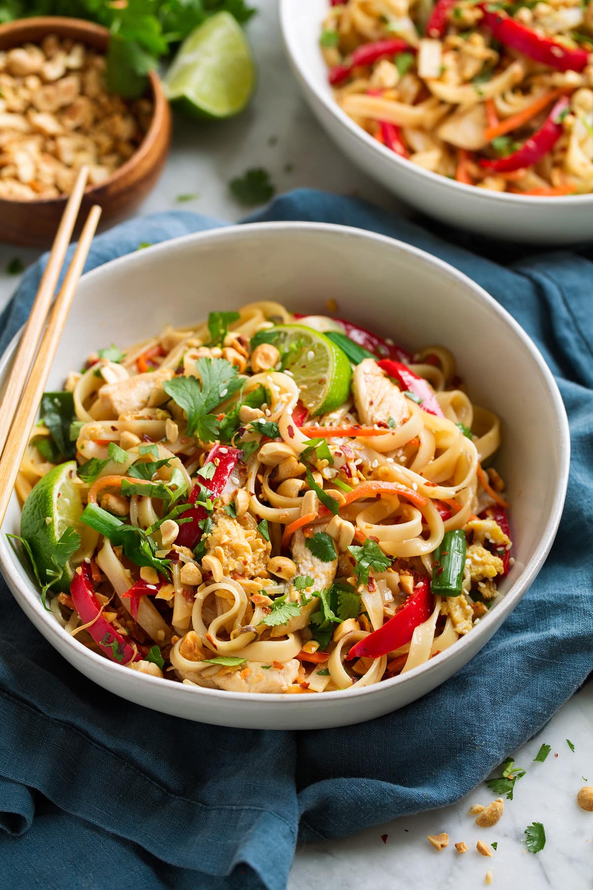 Serving of pad thai in a white bowl.