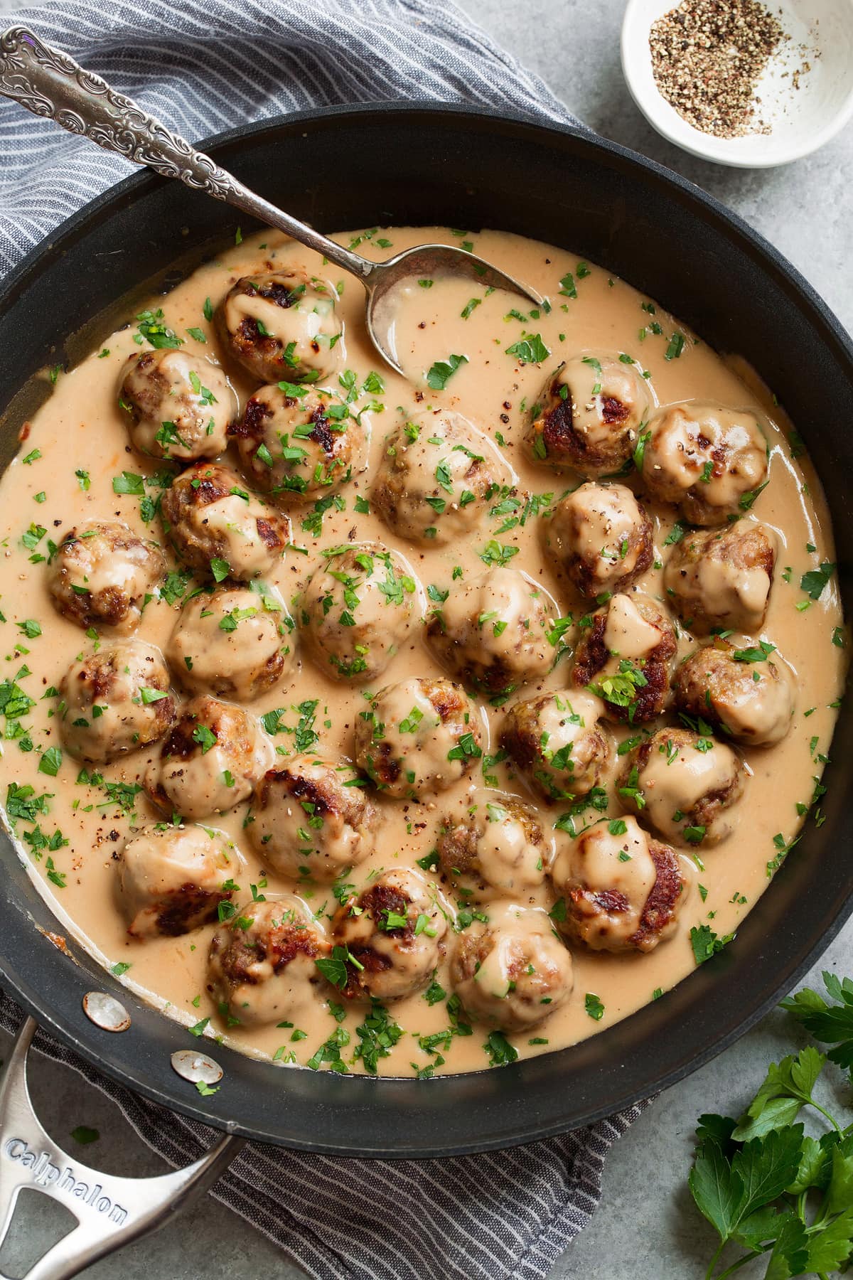 Baked Swedish meatballs in a skillet after tossing with sauce.
