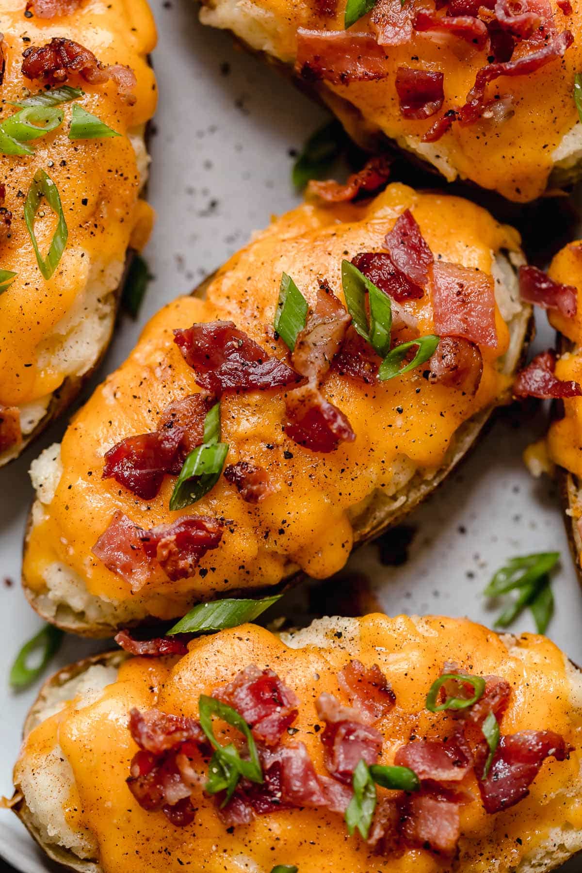 Close up image of twice baked potatoes on a serving plate.