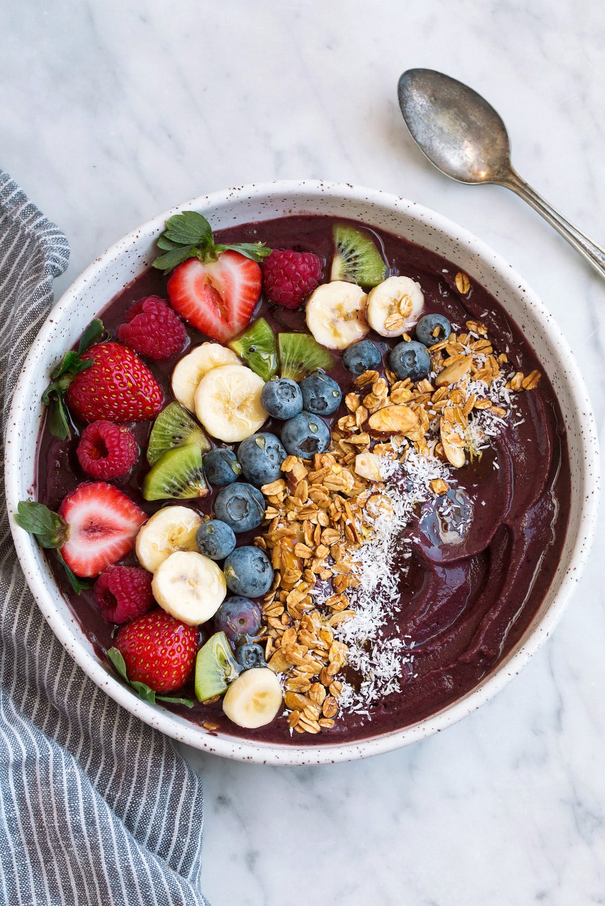 Acai Bowl topped with fresh fruit, granola and coconut in a large bowl.