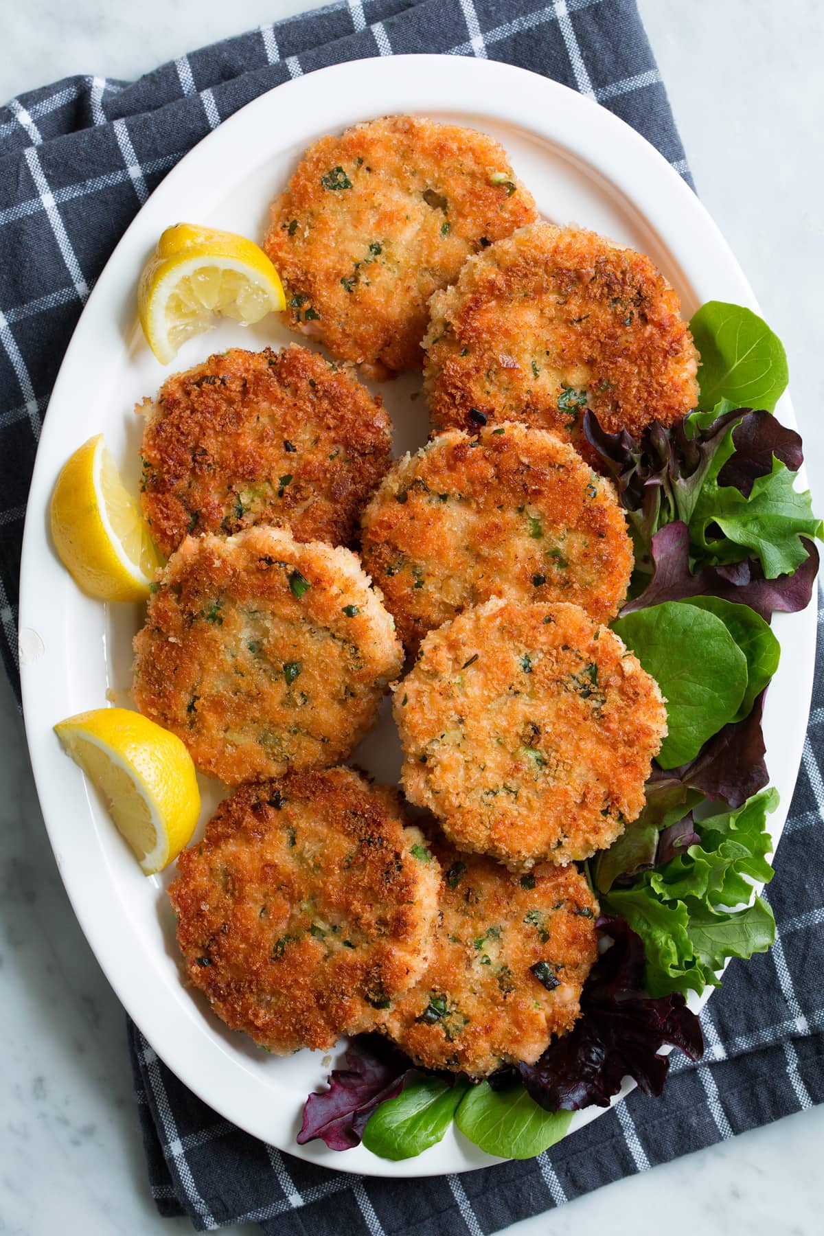 Overhead image of eight salmon cakes on a serving platter.