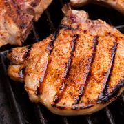 Close up image of pork chop on grill.