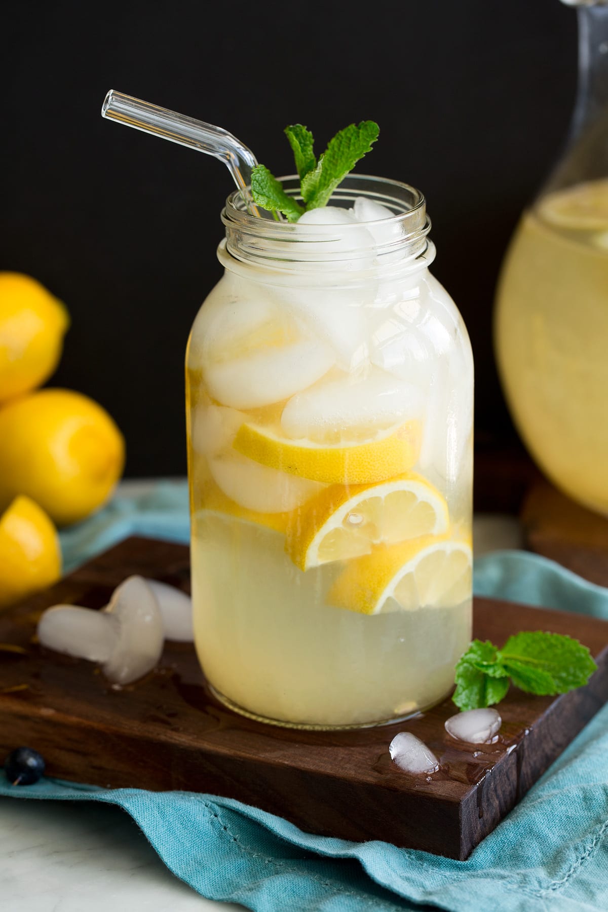 Glass jar full of lemonade and ice.
