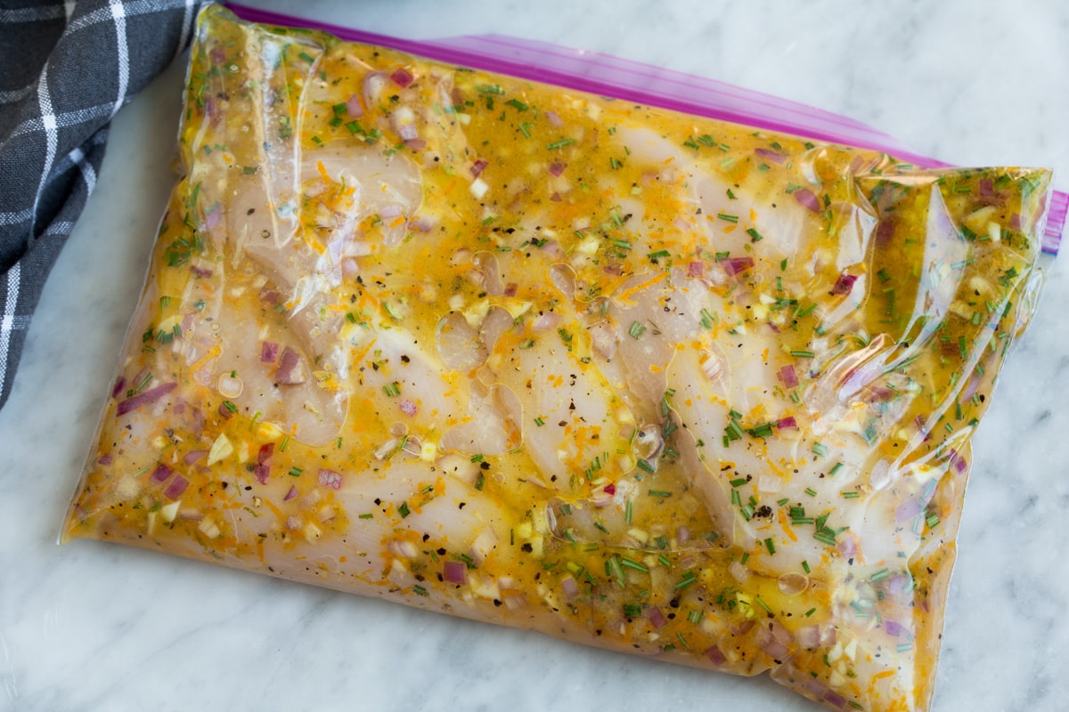 Chicken breasts in marinade in a resealable bag.