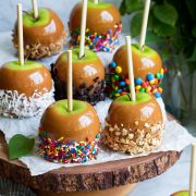 Caramel apples on a wooden cake stand