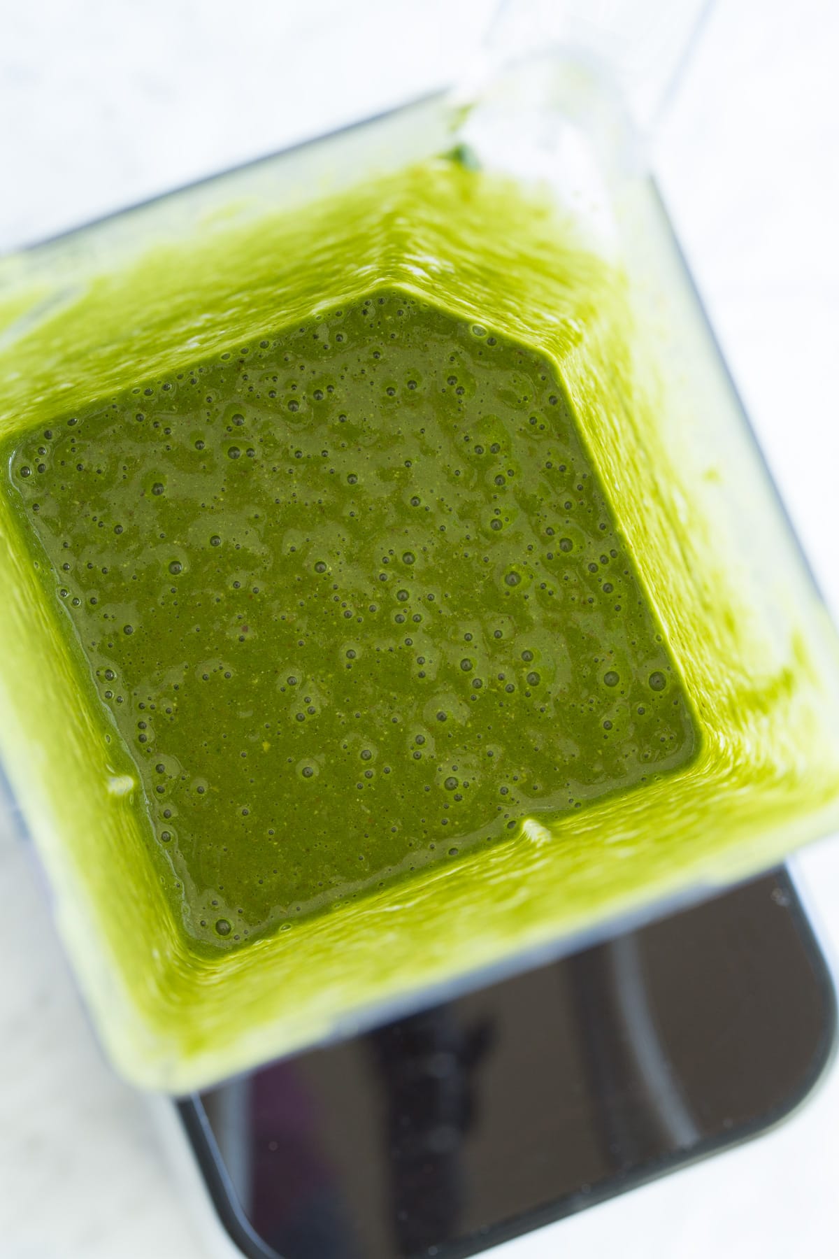 Green smoothie in blender after pureeing. 