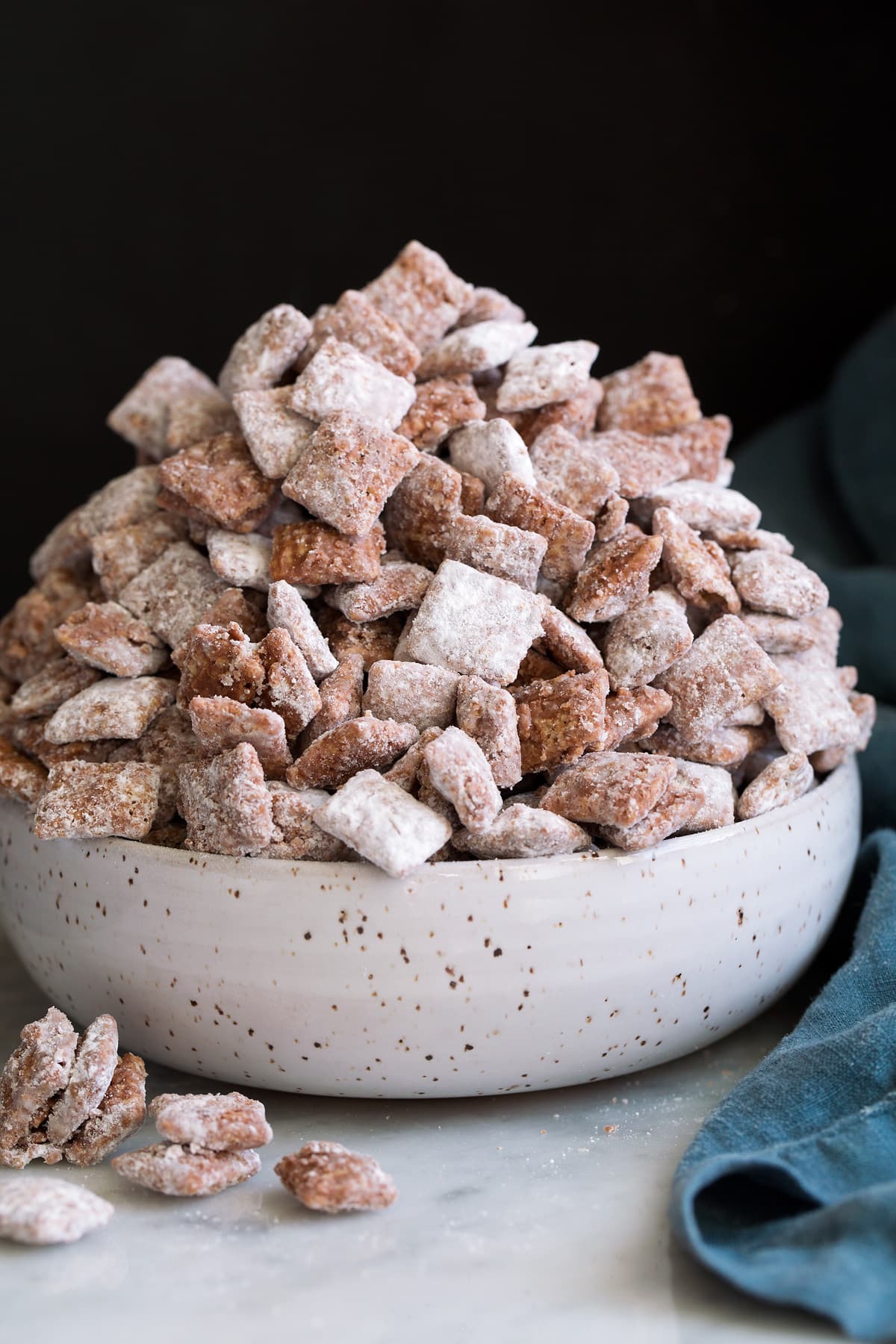 Bowl mounded full of puppy chow muddy buddies.