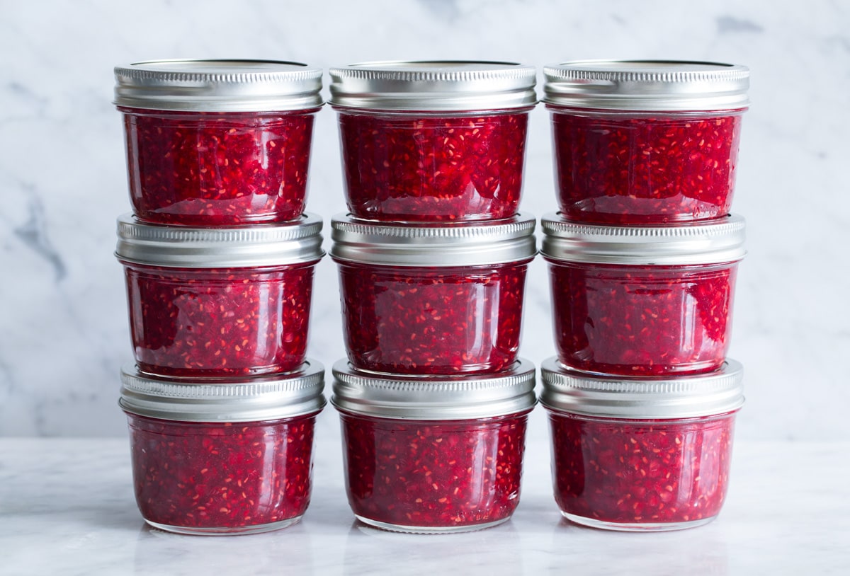 Stacks of homemade raspberry freezer jam.