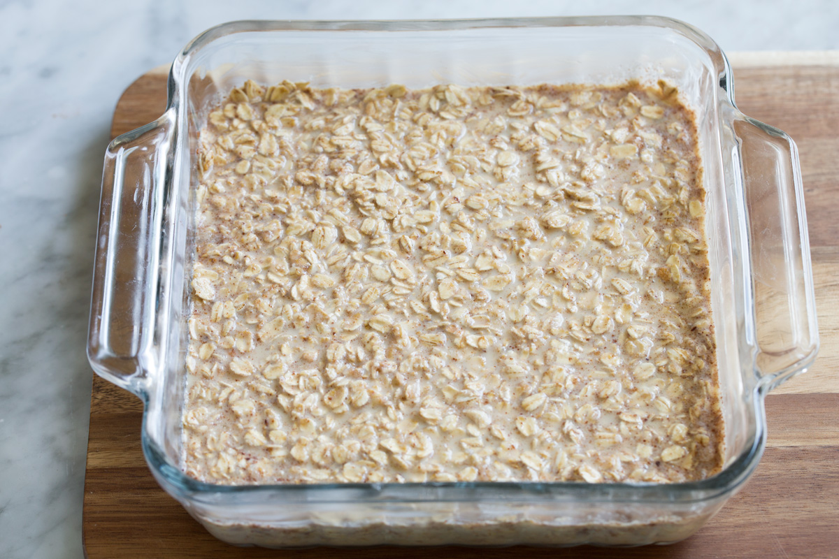 Baked oatmeal mixture in glass baking dish before baking.