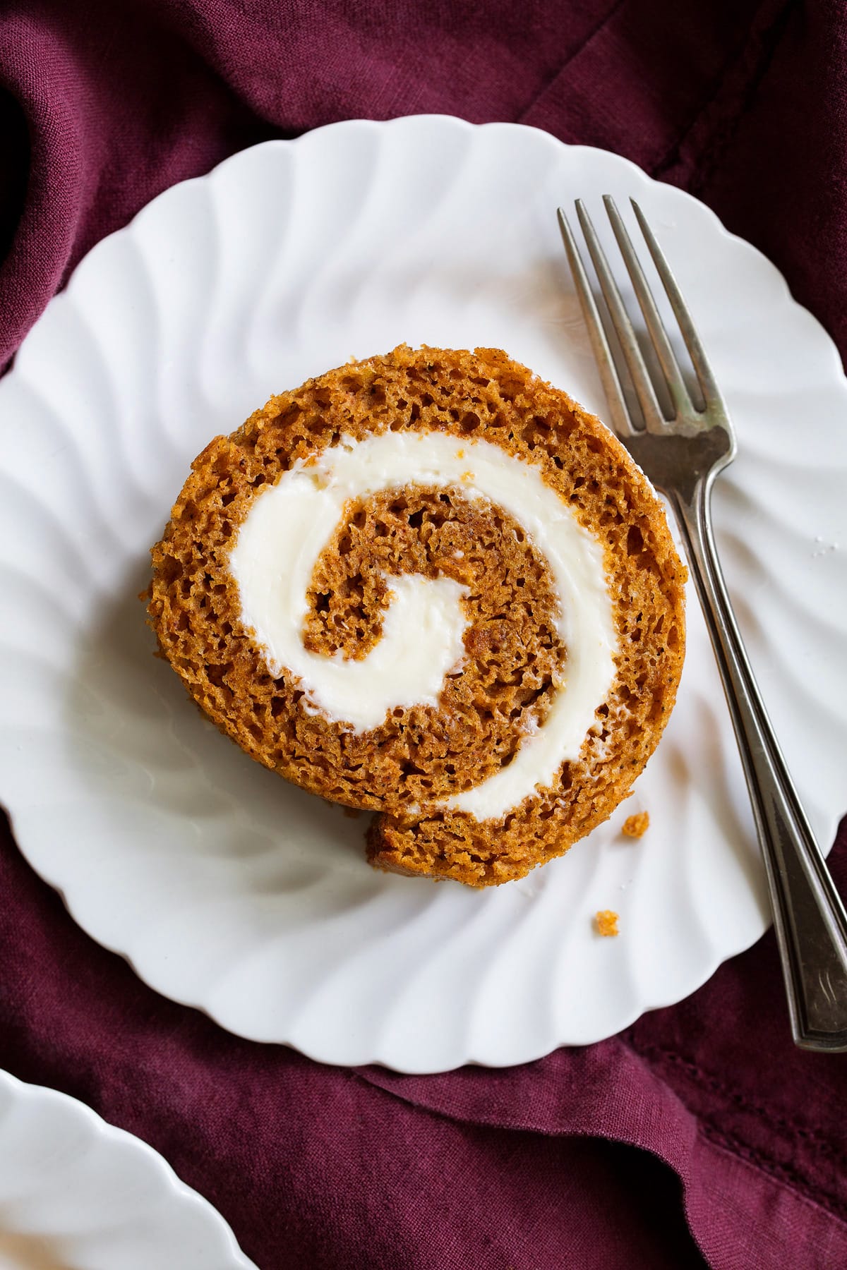 Close up image of one slice of pumpkin roll cake.