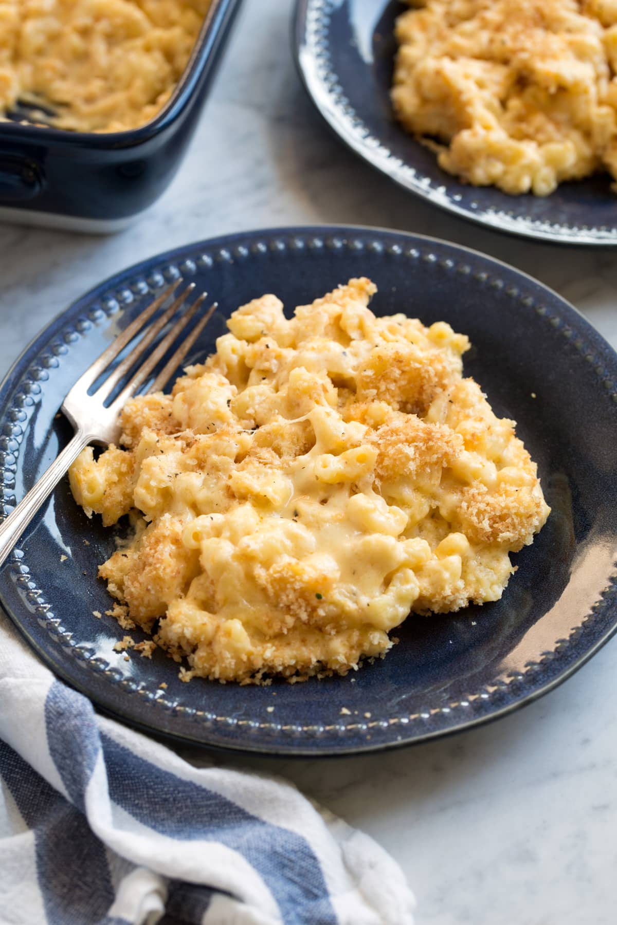 Single serving of Baked Mac and Cheese on a navy blue side plate.