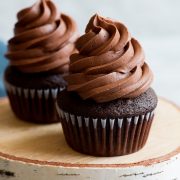 Chocolate buttercream frosting on top of chocolate cupcake