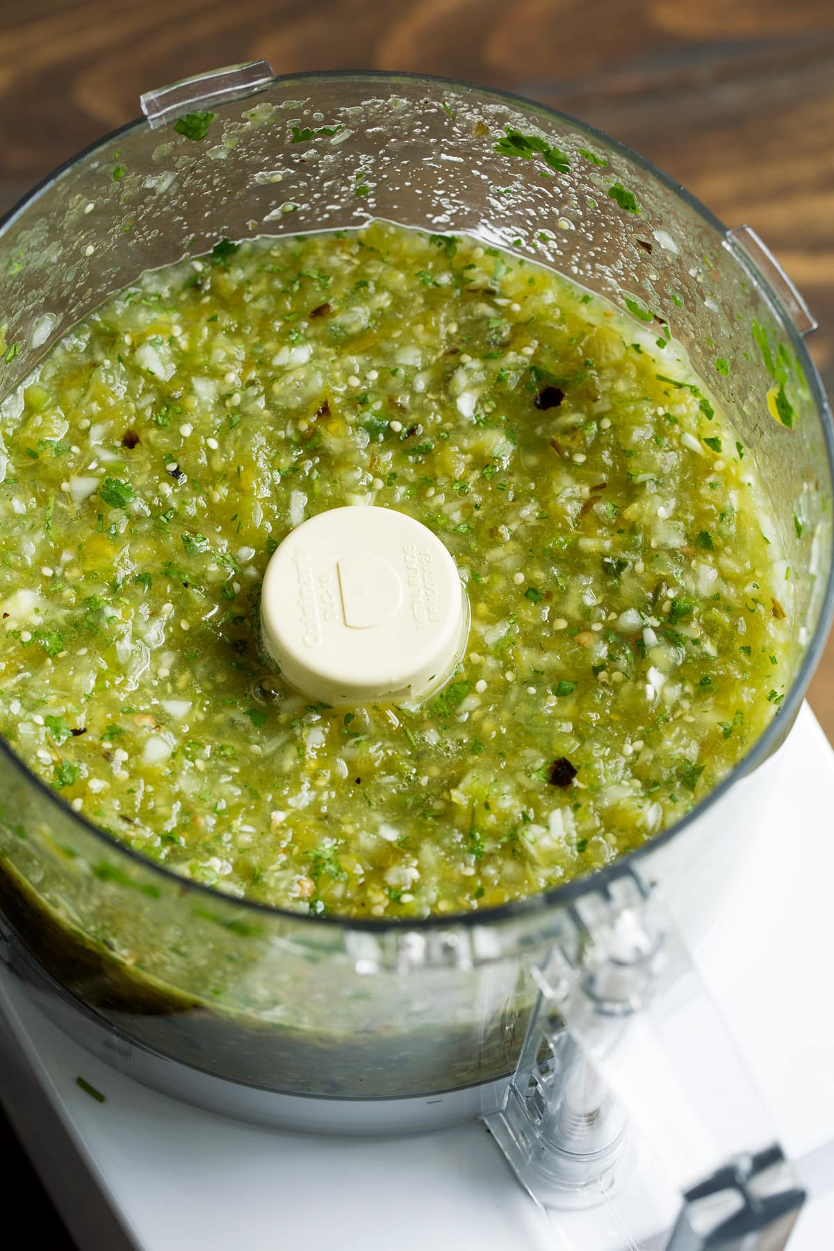 Chopped up salsa verde in a food processor.