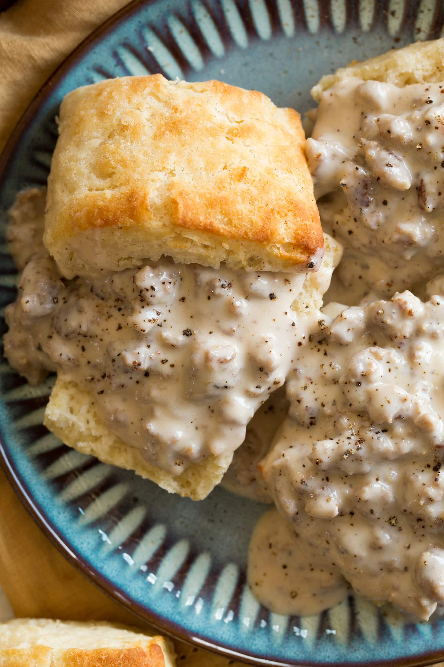 Close up photo overhead of biscuits and gravy.