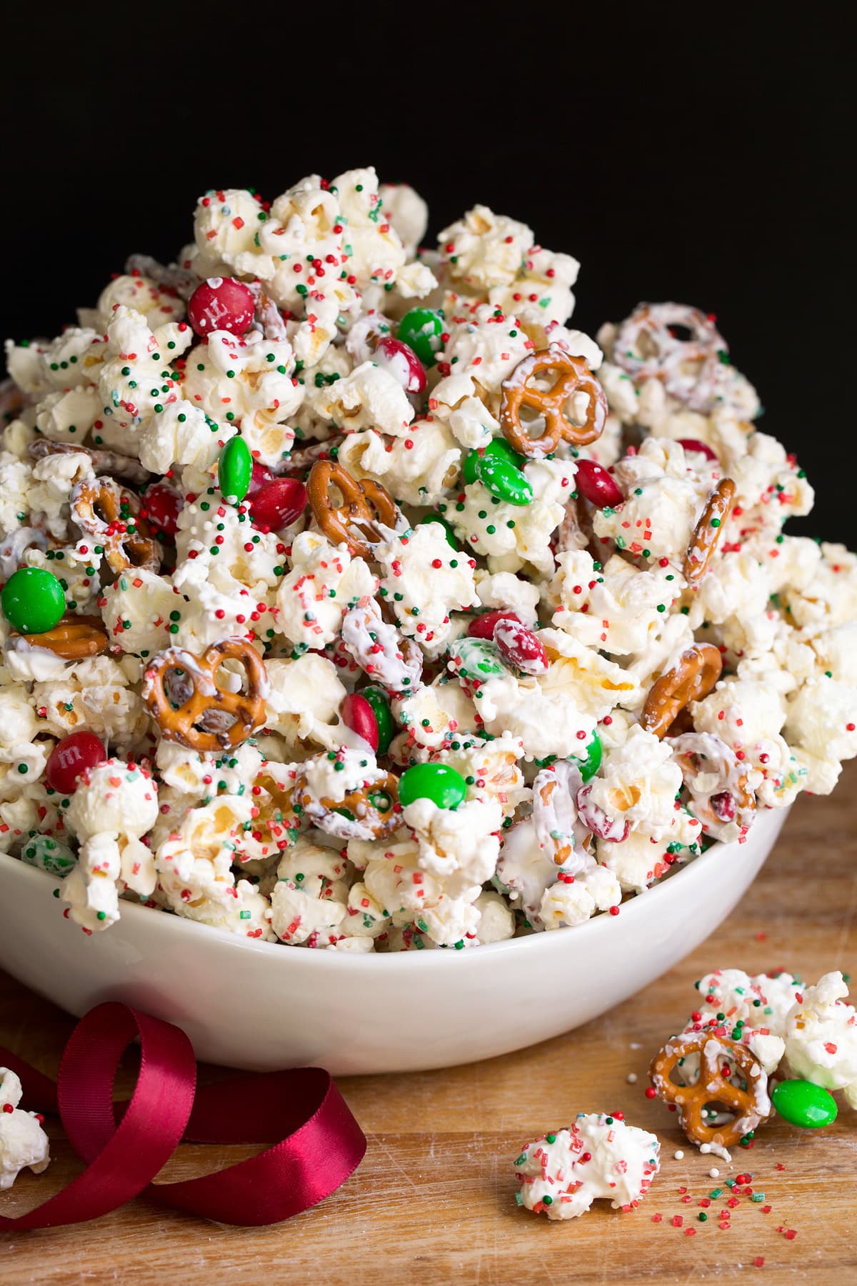 Christmas Crunch popcorn with pretzels, white chocolate coating, m and m's and sprinkles.