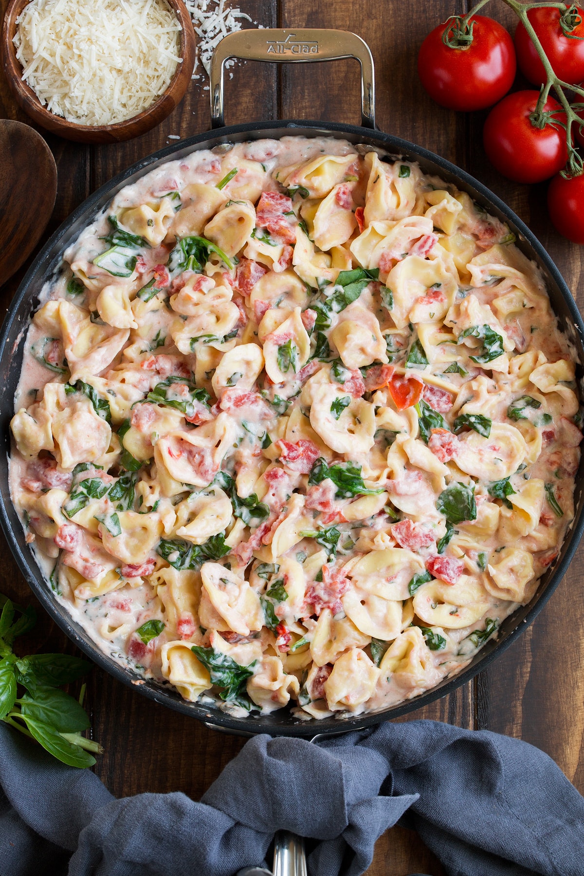 Creamy Spinach Tomato Tortellini shown in a large skillet.
