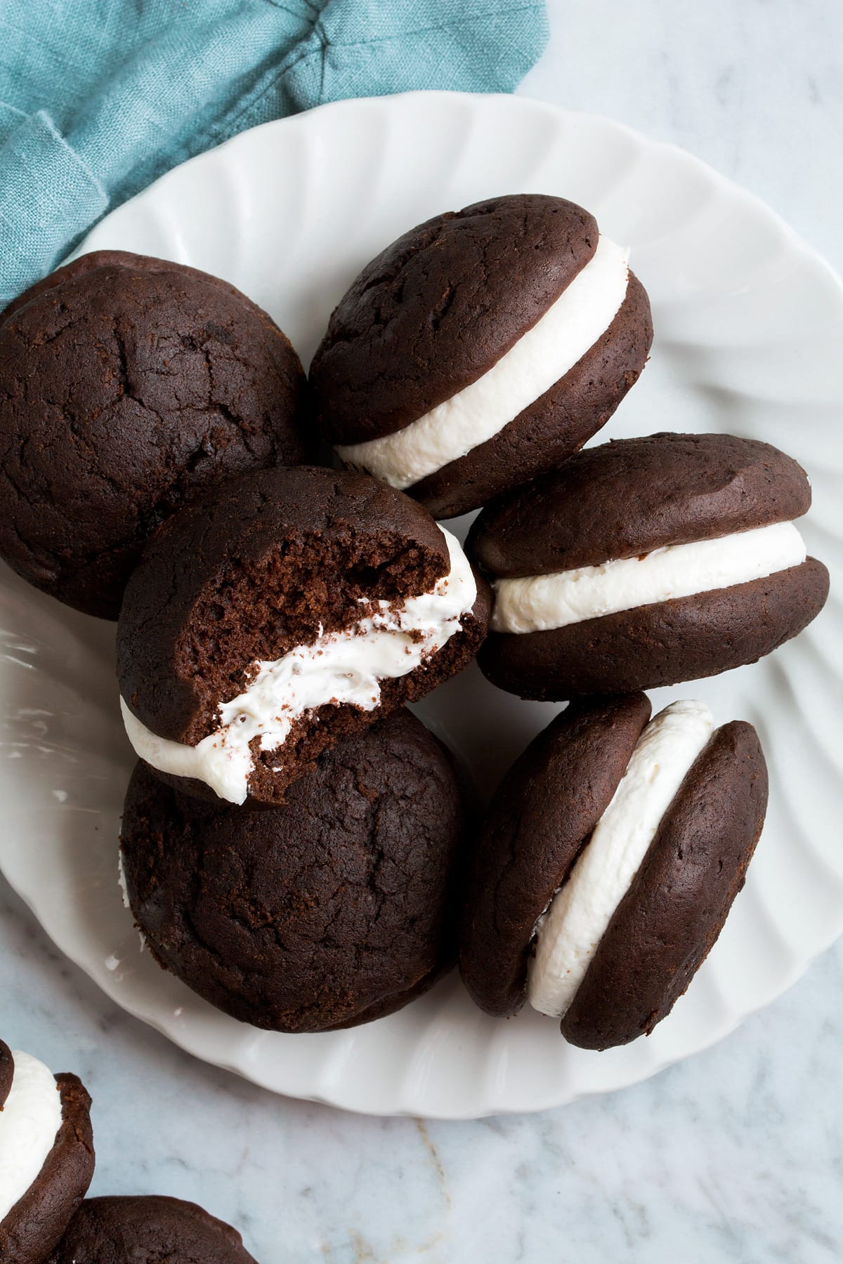 Overhead image of chocolate Whoopie Pies with one broken in half to show texture.