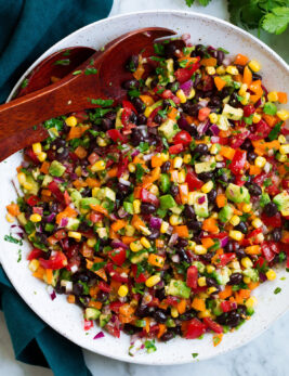 Black bean and corn salad with bell pepper, avocado, tomato and cilantro lime dressing.