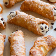 Cannoli on a serving platter, showing one close up.